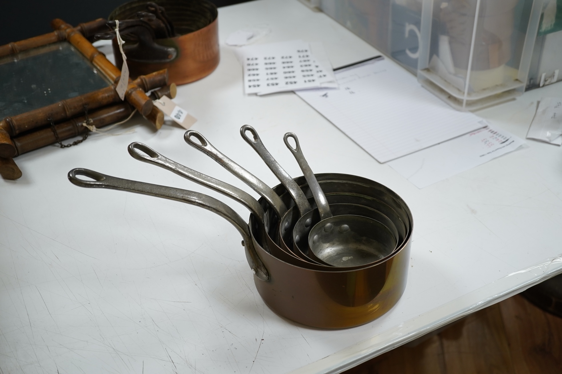 A graduated set of five French copper pans